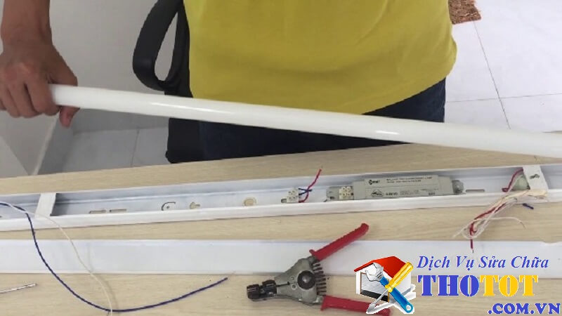 Thợ sửa chữa thay thế bóng đèn điện